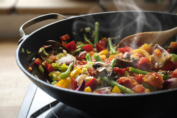 steaming mixed vegetables in the wok, asian style cooking  - Powered by Adobe