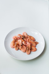 Shrimp on a white plate. Composition on white background