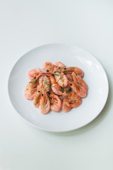 Shrimp on a white plate. Composition on white background