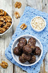 Fototapeta na wymiar Dates cocoa coconut oats walnuts raw vegan balls
