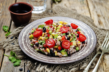Red and white rice black beans corn avocado tomato salad