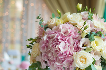 Indoors wedding reception venue with décor, selective focus on flowers