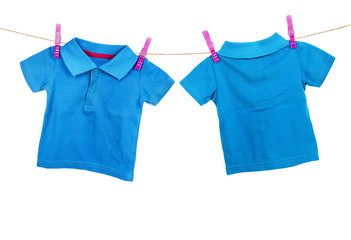Blue t-shirt hanging on the clothesline on white background. Rea