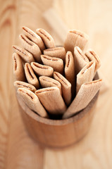 Biscuit sticks with filling on a wooden surface