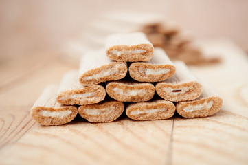 Biscuit sticks with filling on a wooden surface