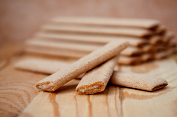 Biscuit sticks with filling on a wooden surface