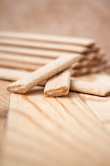 Biscuit sticks with filling on a wooden surface