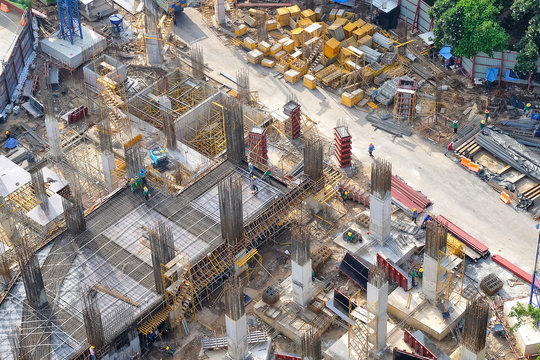 Top view of building foundation and worker at construction site