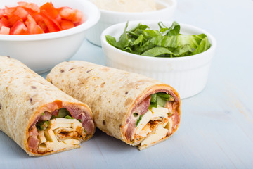Wrap with tomato, lettuce, harissa and hoummous.