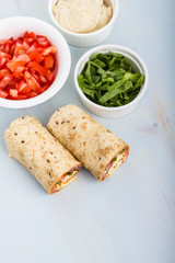Wrap with tomato, lettuce, harissa and hoummous.