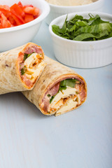 Wrap with tomato, lettuce, harissa and hoummous.