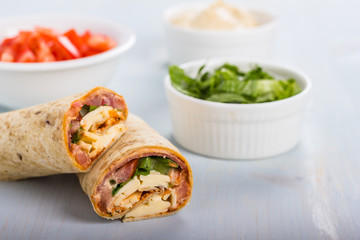 Wrap with tomato, lettuce, harissa and hoummous.