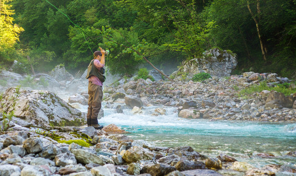 A fly fisherman fishing in a river