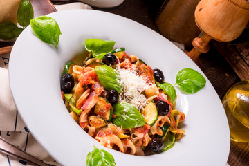 Ribbon Pasta with zucchini and olives in tomato sauce