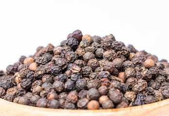Macro of black peppercorns - black pepper grains.