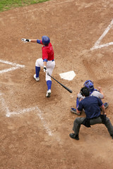 A batter takes a big swing and gets a hit