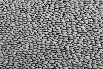 Naklejka premium Historic pavement composed of many pebble stones texture