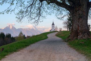 Jamnik church on a hillside at sunset