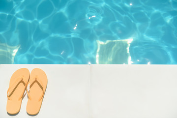 Flip flop shoes near blue water