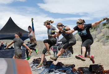 Spartan Race, Fort Carson, CO May 2015
Five women competitors jumping over fire to the finish line...