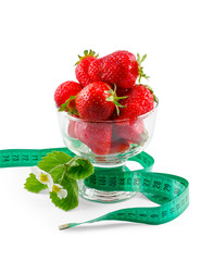 strawberries in a glass vase and measuring tape isolated on a wh