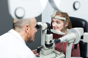 Fototapeta na wymiar Optician doing eye examination