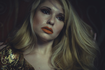 Blonde with long hair and gold with red skull armor and golden t