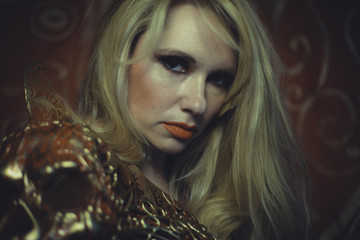 Vogue, Blonde with long hair and gold with red skull armor and g