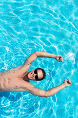 Positive man swimming in a pool