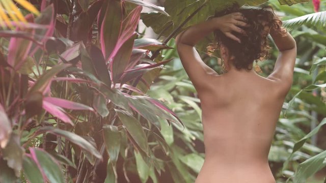 Hispanic woman naked in the jungle doing sensual movements. 4k