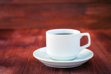 Cup of coffee on a wooden table.