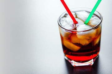 soft drinks. Cola glass with ice cubes on a white background