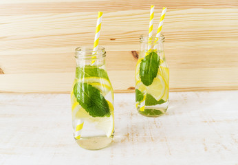 Water with mint and lemon in glass bottle