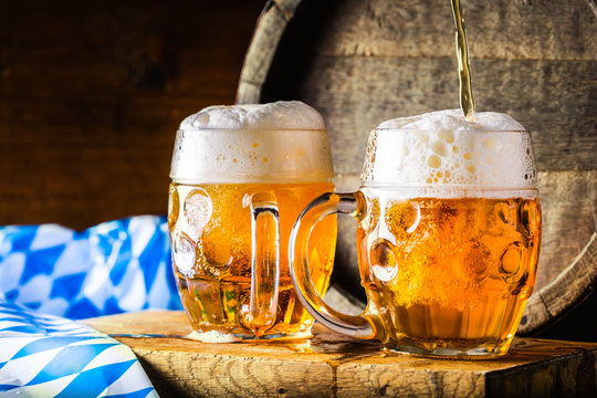 Beer. Oktoberfest.Two cold beers. Draft beer. Draft ale. Golden beer. Golden ale. Two gold beer with froth on top. Draft cold beer in glass jars in pub hotel or restaurant. Still life.