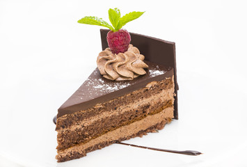 piece of chocolate cream cake on a white background in the restaurant