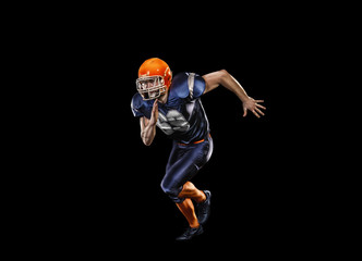 Professional american football player in action isolated on the black