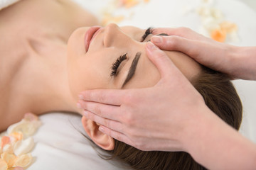 Professional beautician massaging human face