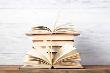 Open book, hardback books on wooden table. Education background. Back to school. Copy space for text.