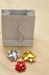 Silver gift bag with a variety of colorful bows