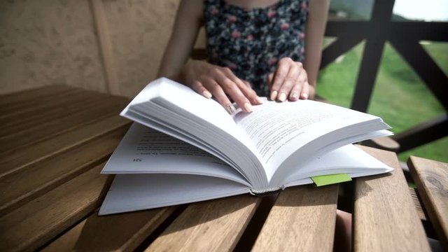 woman reading a book in a park