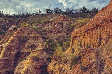 Scenic view of unique steep eroded sandstone cliffs of the Red Ravine (Romanian: Rapa Rosie), a...