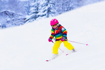 Little girl skiing in the mountains