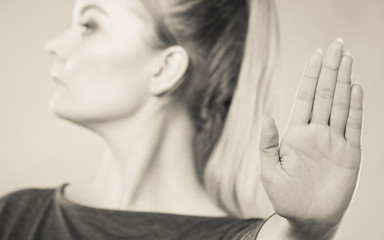 Assertive woman making stop gesture. - obrazy, fototapety, plakaty