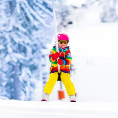Naklejka premium Child on ski lift