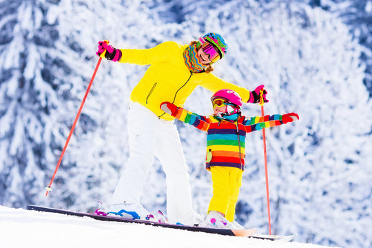 Mother and little girl learning to ski