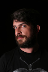 Bearded man wearing shirt with interesting look. Close.up. Black