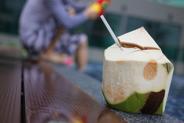 Drinking coconut juice in the swimming pool
