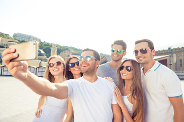 joyful happy boyfriends and  girlfriends make selfie photo with