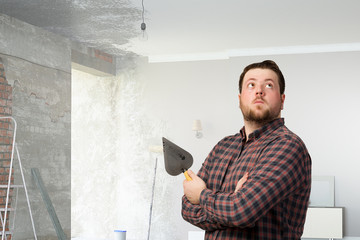Handyman with tool in interior . Mixed media