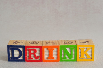 The word drink spelled with alphabet blocks isolated on a white